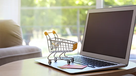 kleine winkelwagen op het toetsenbord van een laptop