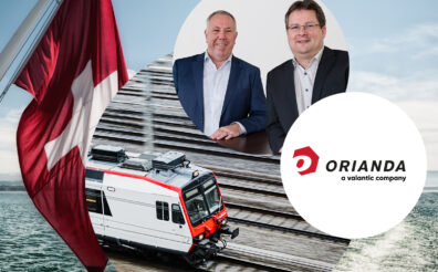Picture by Ewald Rehm and Rene Balser, next to it the Orianda - a valantic company logo, a train and in the background the swiss flag | valantic Extends SAP Services With Asset Management Consultancy Orianda