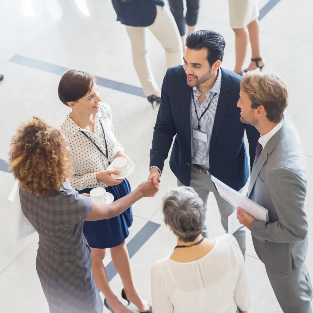 High angle view of group of business people shaking hands