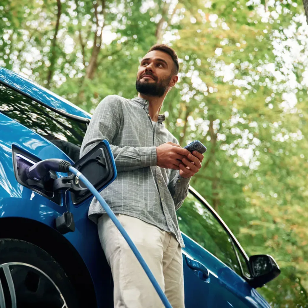 man charging electric car