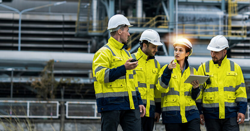 Four engineers holding tablet outside working on asset management and asset collaboration