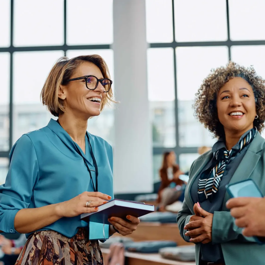 People smiling and talking at an event
