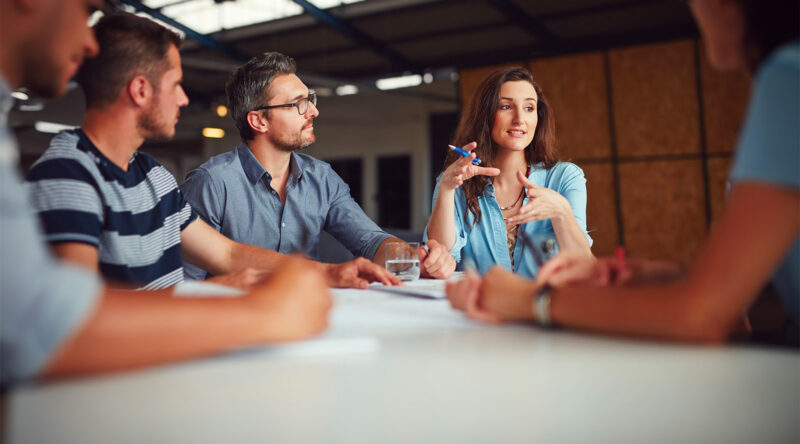 Shot of a group of coworkers having a meeting in an open plan office