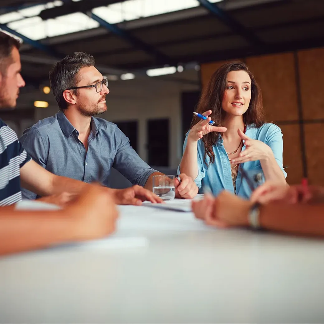 Shot of a group of coworkers having a meeting in an open plan office