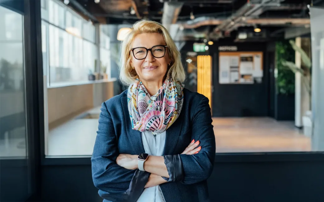 Portrait of smiling, confident mature businesswoman, in modern office.