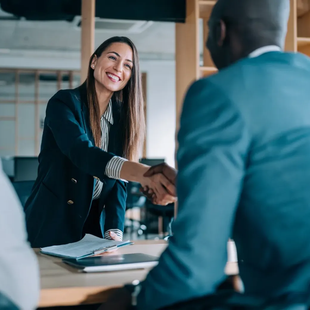 Business people shaking hands in the office. Group of business persons in business meeting. Three entrepreneurs on meeting in board room.