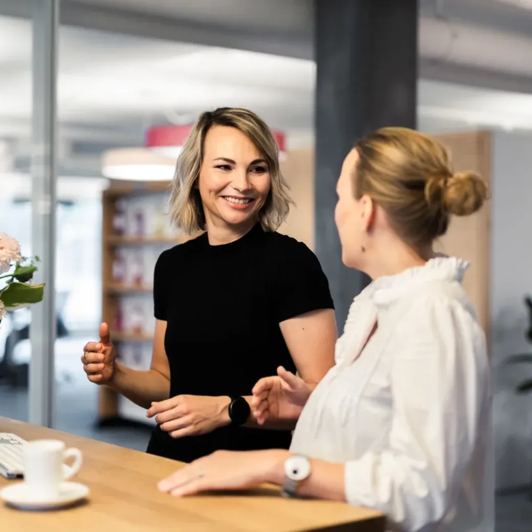 Two valantic employees talk to each other