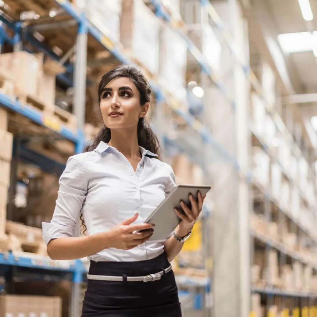 woman standing in warehouse with IPad