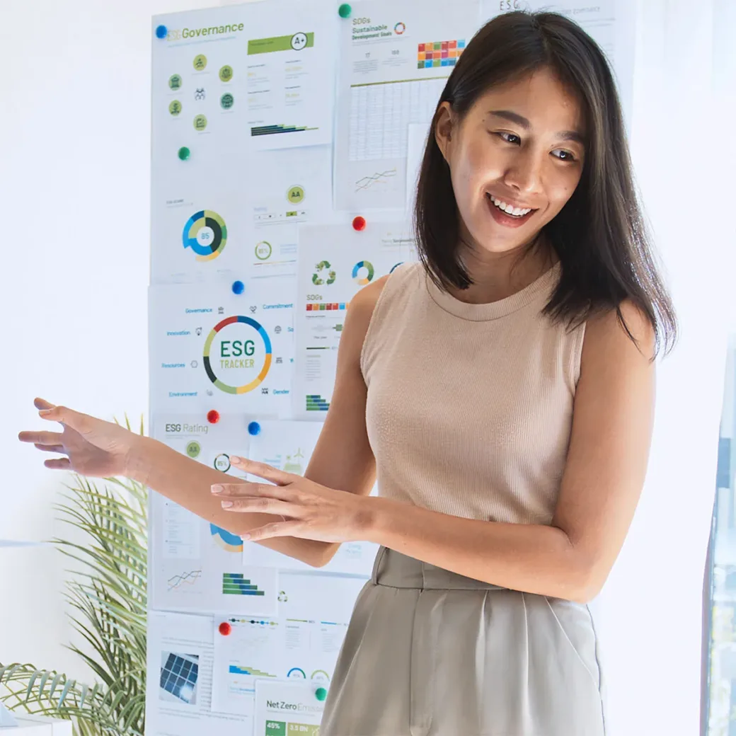 Woman lead young group of businesspeople in team meeting, using laptop computer for ESG topic presentation on monitor. Sustainable business practice, people work at home concept